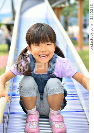 Girl playing on the slide 3335288