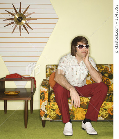 Man sitting on sofa. 3345355