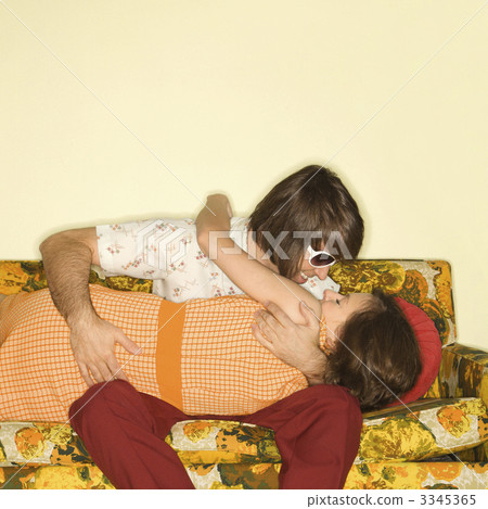 Couple kissing on sofa. Couple kissing on sofa. 3345365