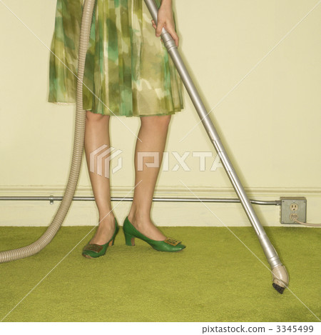 Woman vacuuming rug. 3345499