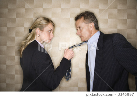 Angry Businesswoman Pulling Man's Tie Angry Businesswoman Pulling Man's Tie 3345997