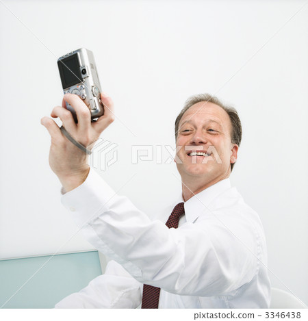 Businessman taking photo of self 3346438
