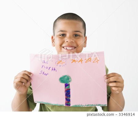 Smiling hispanic boy holding drawing. Smiling hispanic boy holding drawing. 3346914