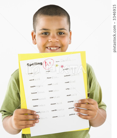 Smiling hispanic boy holding homework. Smiling hispanic boy holding homework. 3346915