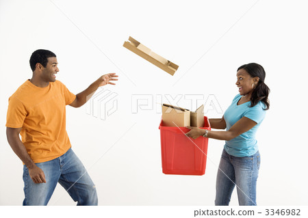 Man throwing cardboard into bin. 3346982