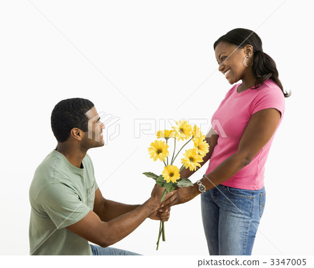 Man giving woman flowers. 3347005