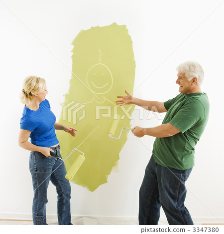 Couple laughing at smiley face painting. 3347380