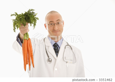 Doctor holding carrots. Doctor holding carrots. 3351462