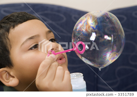 Boy blowing bubble. 3351789