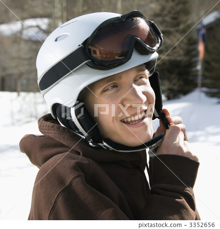 Teenager fastening helmet. 3352656