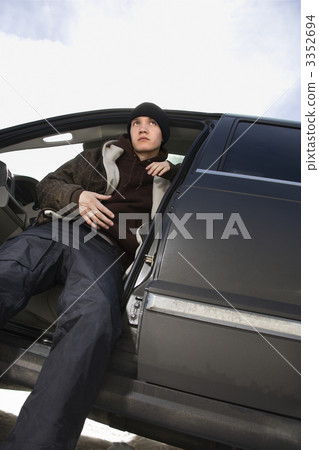 Teenager sitting in SUV. 3352694