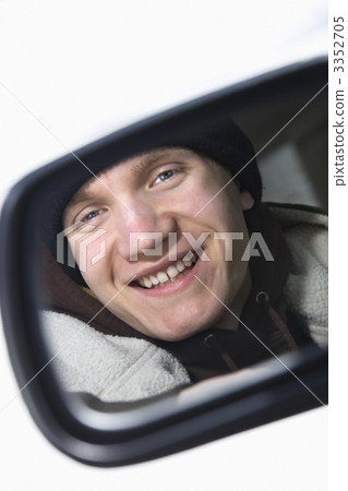 Teen in side view mirror. 3352705