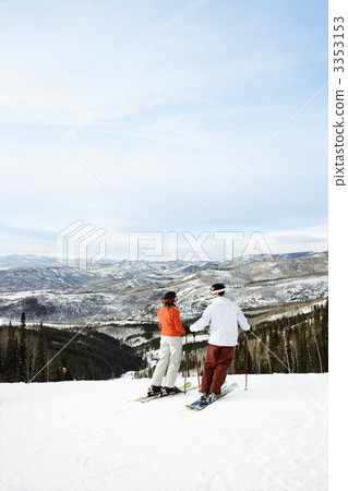 Skiers on Mountain Overlooking Valley Skiers on Mountain Overlooking Valley 3353153