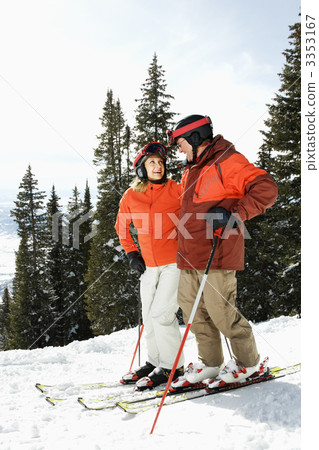 Couple on Skis on Mountain Slope 3353167