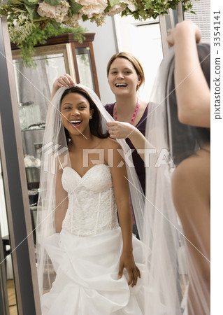 Seamstress helping bride. Seamstress helping bride. 3354141