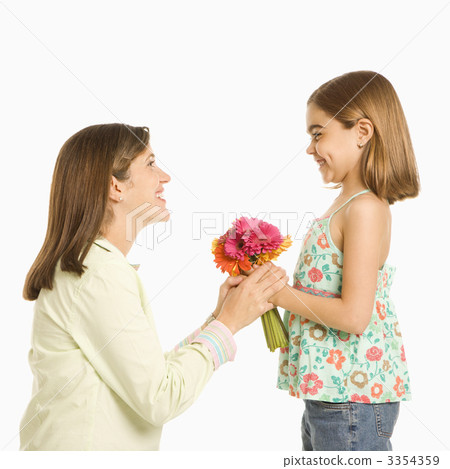 Daughter giving mother flowers. 3354359