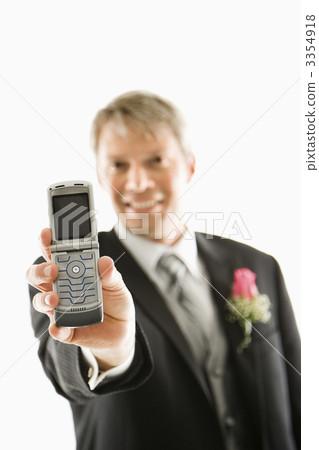 Groom holding cellphone. 3354918
