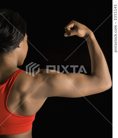 Woman flexing bicep. Woman flexing bicep. 3355145
