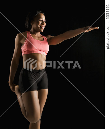 Muscular woman stretching. 3355161