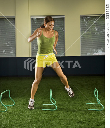 Woman jumping hurdles. 3355285