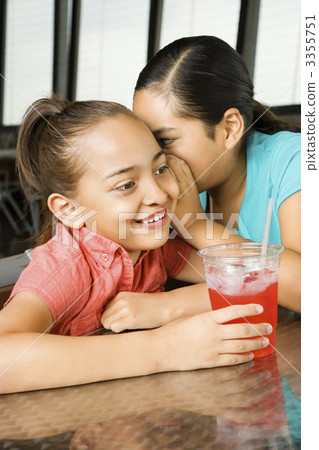 Young Girl Whispering to Another 3355751