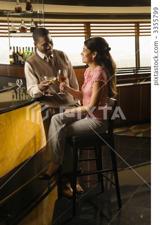 Couple toasting drinks. 3355799