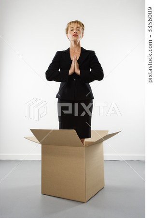 Woman meditating in box. 3356009