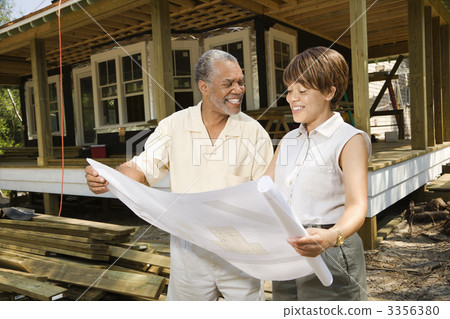 Couple Holding Building Plans Couple Holding Building Plans 3356380