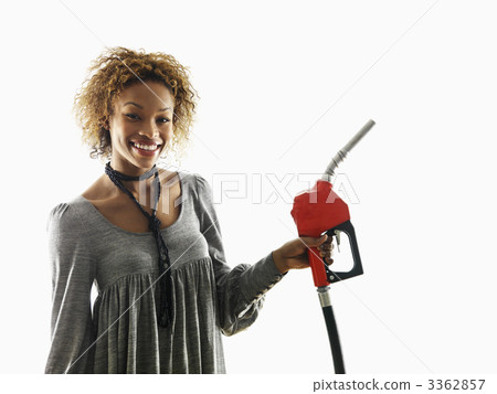 Woman holding fuel pump nozzle Woman holding fuel pump nozzle 3362857