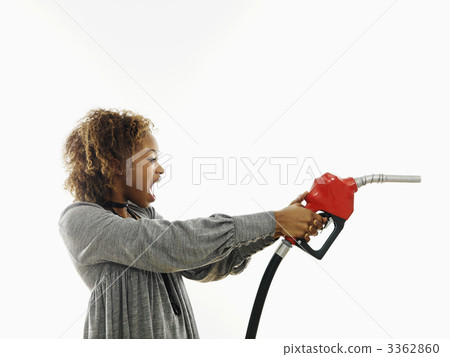 Angry woman with gas nozzle 3362860