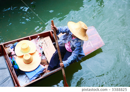 Vendor on traditional floating market in Thailand Vendor on traditional floating market in Thailand 3388825