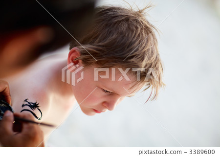 Boy having henna tattoo Boy having henna tattoo 3389600