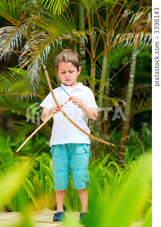 Cute boy playing with bow and arrows 3390143