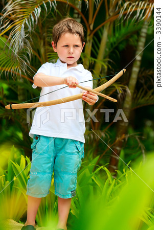 Cute boy playing with bow and arrows 3390144