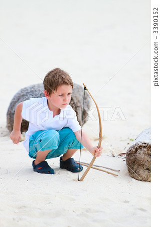 Cute boy playing with bow and arrows 3390152