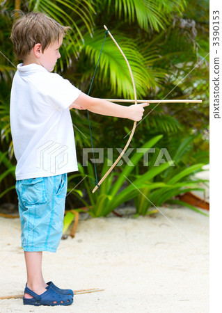 Cute boy playing with bow and arrows 3390153