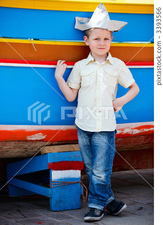 Boy near colorful boat Boy near colorful boat 3393566