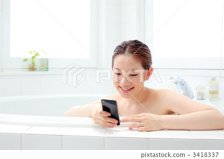 Girls using smartphones in the bathroom Girls using smartphones in the bathroom 3418337