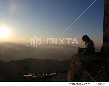 A woman to meditate at Sarankot hill in Nepal ~ 3430503