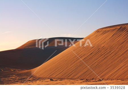Sand dunes stained red at sunset 3539328