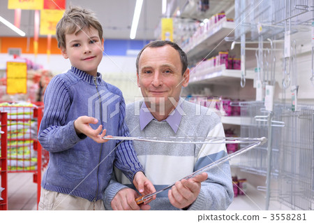 elderly man with boy in store with grill for roasting in hands elderly man with boy in store with grill for roasting in hands 3558281