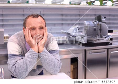bored seller in shop with empty shelves and counters 3558397