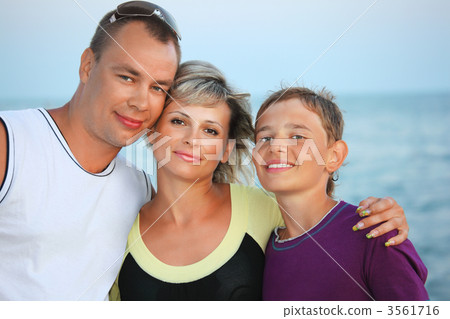 Happy family with smiling boy on beach in evening 3561716