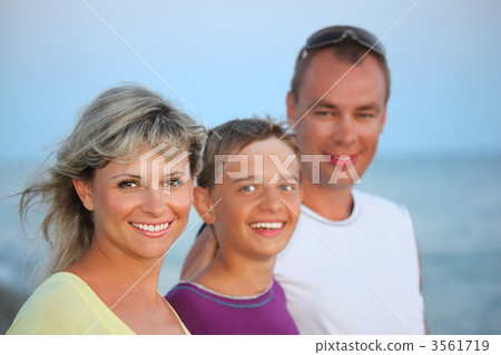 Happy family with smiling boy on beach in evening 3561719