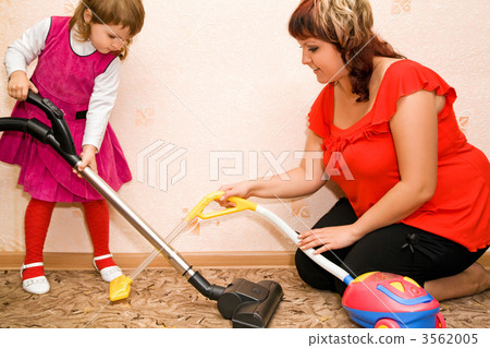 Little Girl and woman vacuum a carpet 3562005