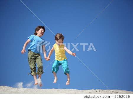 Two boys jump on sand Two boys jump on sand 3562026