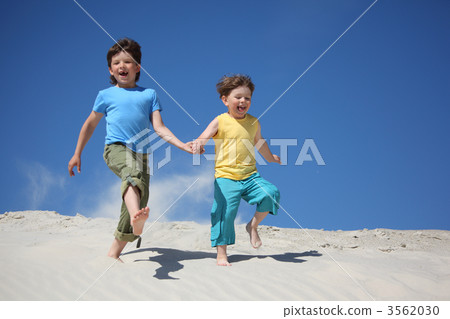 Two boys run on sand Two boys run on sand 3562030