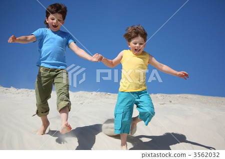 Two boys run on sand Two boys run on sand 3562032