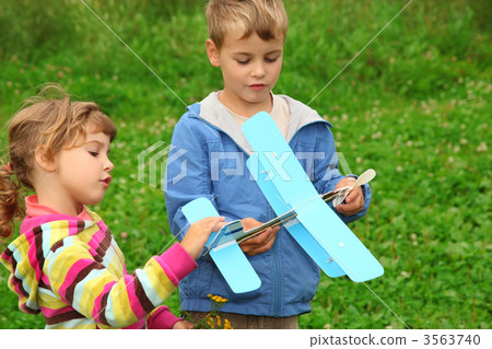 little girl and boy with toy airplane in hands outdoor 3563740