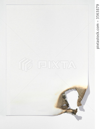 the sheet of paper by the burned edge against the white background 3563879
